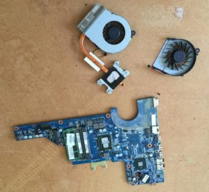 Picture of a small laptop motherboard, CPU heatsink and fan. This laptop was dirty and all components needed a thorough clean. Afterwards the laptop was running at normal speed and sound levels.