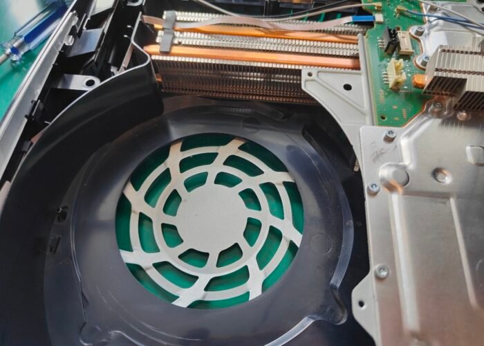 A clean PlayStation 5 showing part of the fan area and a dust-free heatsink.