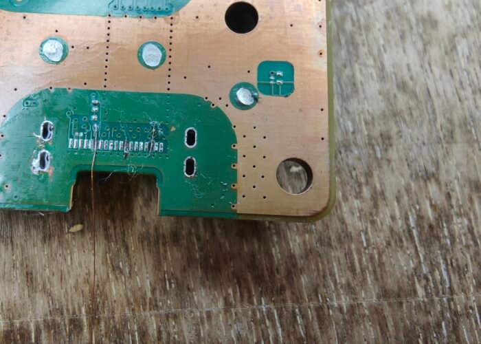 Near the begining of trace repairing on a PS5 HDMI ports connector pads. Here wires are being connected from near the port to where the pads should be, ready to be set in place with some conformal coating.
